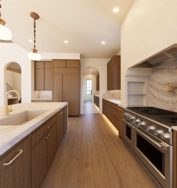Designed with both beauty and utility in mind, this chef’s kitchen offers a seamless workflow framed by warm wood cabinetry and tailored stone surfaces. Subtle lighting and thoughtful storage elevate the everyday, creating a space that feels as refined as it is functional.