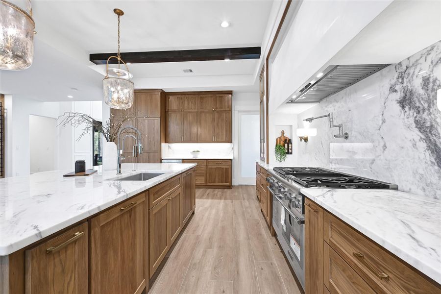 Custom cabinets (built on-site) with marble back splash and Venetian Stucco Hood