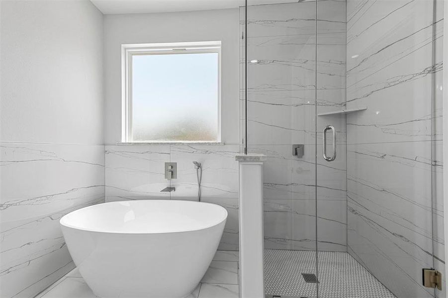 Bathroom with tile walls and plus walk in shower