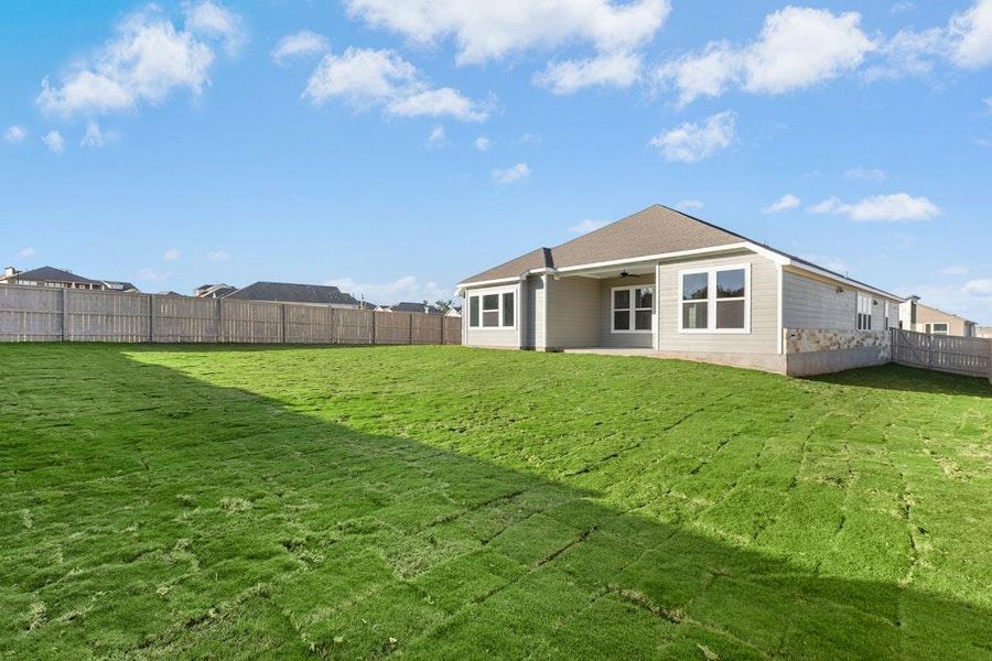 Rear view of house featuring a patio, a fenced backyard, and a ceiling fan