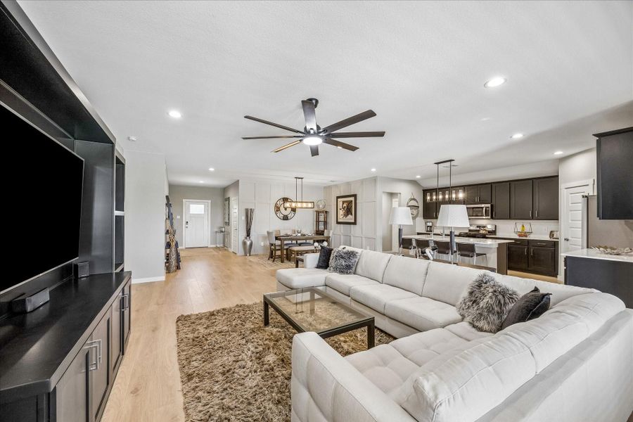 And this is a view from the living room back towards the kitchen, dining room and foyer.  Custom fan in the living room and upgraded pendant lighting in dining room and kitchen.