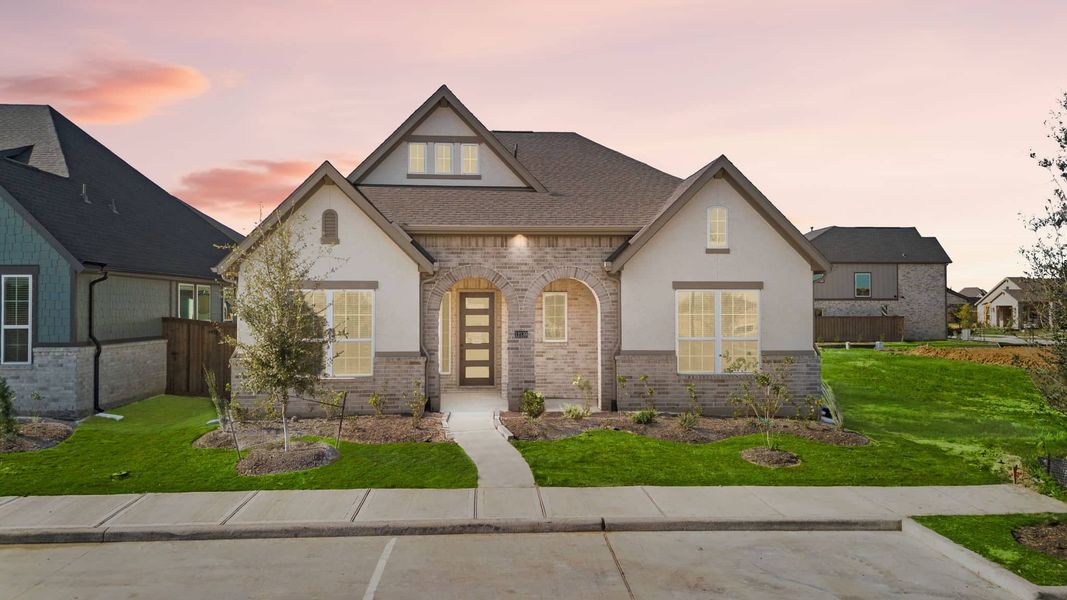 Front exterior of a new home in Riceland, Mont Belvieu, TX, highlighting curb appeal (Image 2). Front exterior of a new home in Riceland, Mont Belvieu, TX, highlighting curb appeal (Image 2).