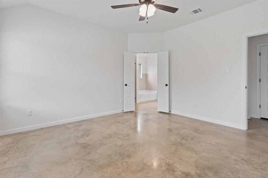 Spare room featuring lofted ceiling and ceiling fan