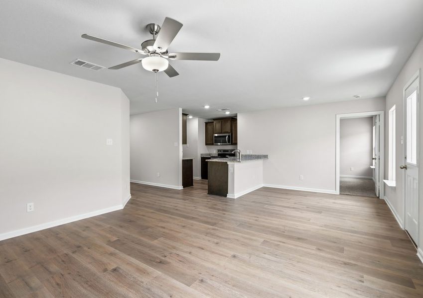 The family room sits adjacent to the dining room and kitchen. The family room sits adjacent to the dining room and kitchen.