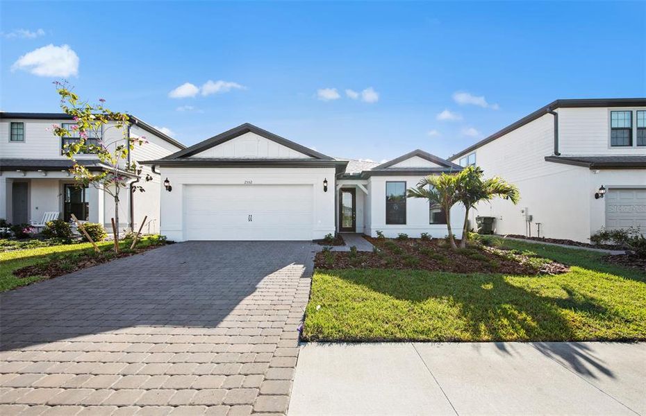 Front exterior of a new home in Cedar Grove at The Woodlands, North Port, FL, highlighting curb appeal (Image 2).