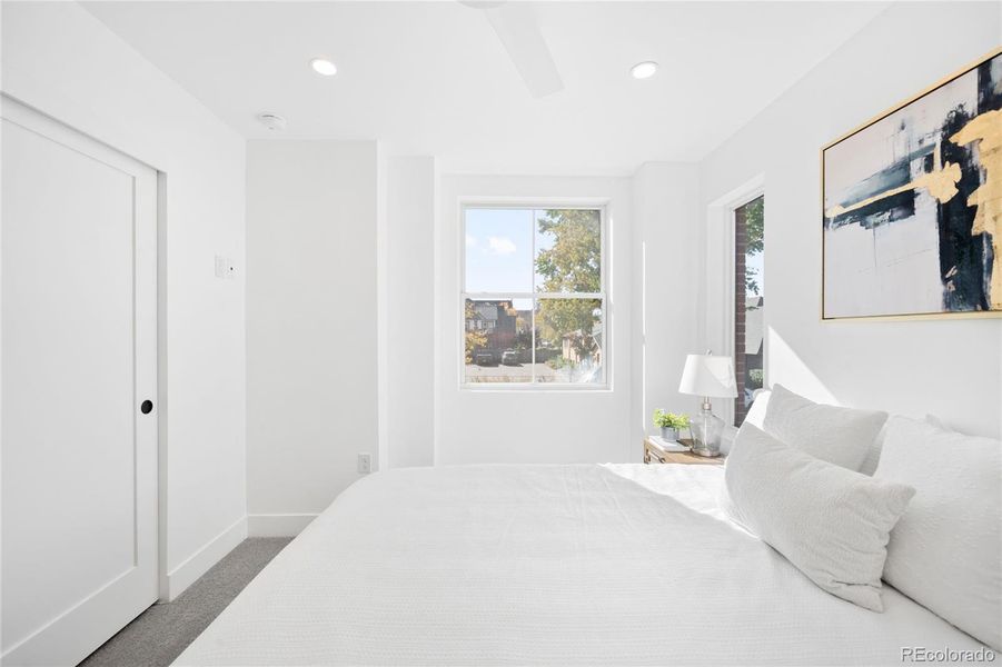 The primary bedroom is filled with natural light, offering a bright and peaceful modern retreat.