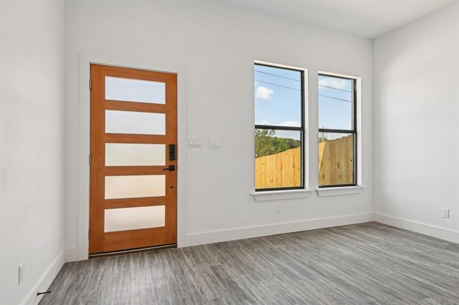 Spare room with wood finished floors and baseboards Spare room with wood finished floors and baseboards