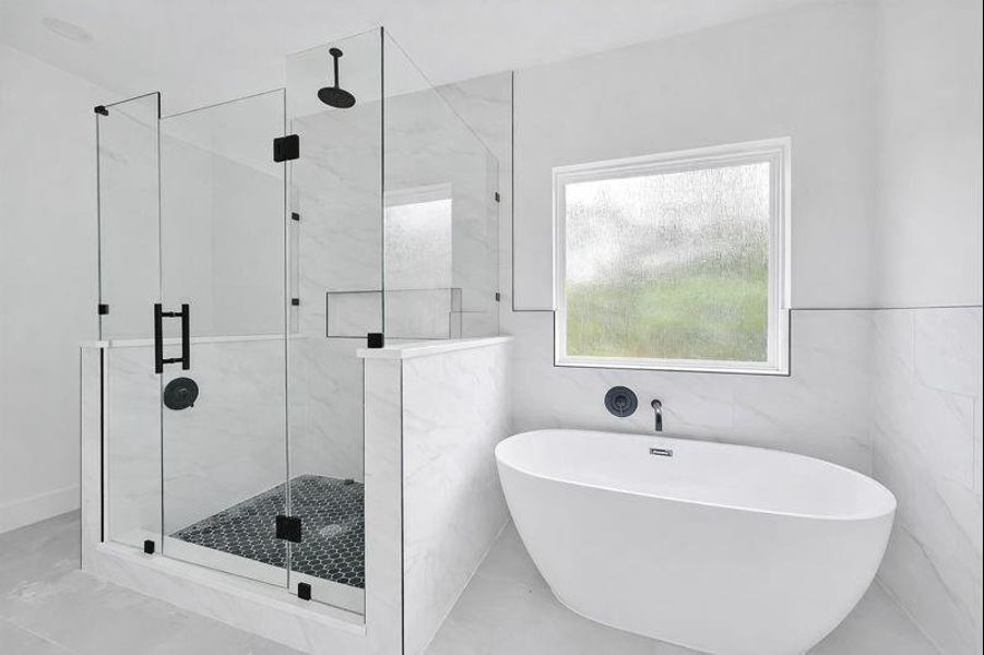 full bath featuring a soaking tub and modern tile surround.