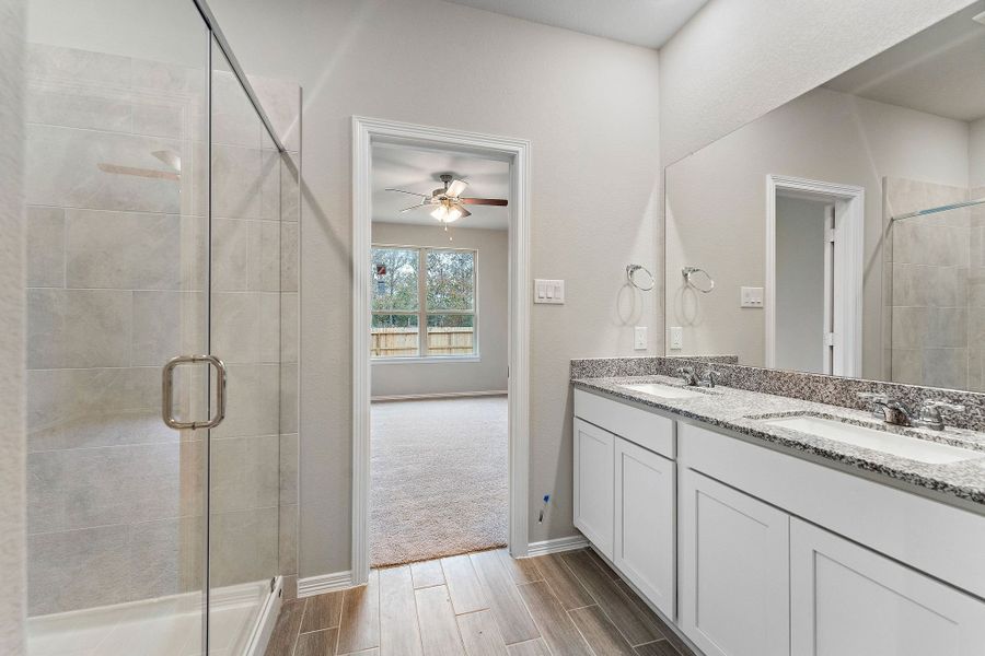 A bathroom with a shower unit and a glass door. A bathroom with a shower unit and a glass door.