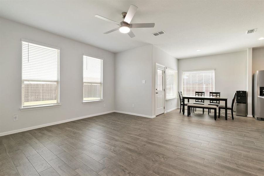 Living room with wood finished floors, ceiling fan, and recessed lighting
