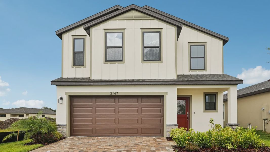 Front exterior of a new home in Grasslands West, Lakeland, FL, highlighting curb appeal (Image 23).