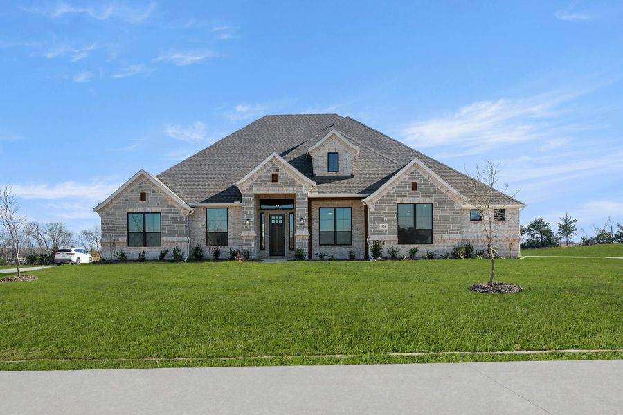 Front exterior of a new home in Heritage, McLendon-Chisholm, TX, highlighting curb appeal (Image 1). Front exterior of a new home in Heritage, McLendon-Chisholm, TX, highlighting curb appeal (Image 1).