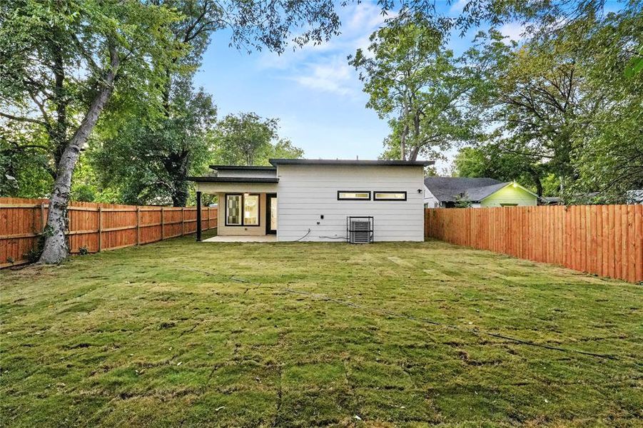 Rear view of property featuring a patio area and a fenced backyard Rear view of property featuring a patio area and a fenced backyard