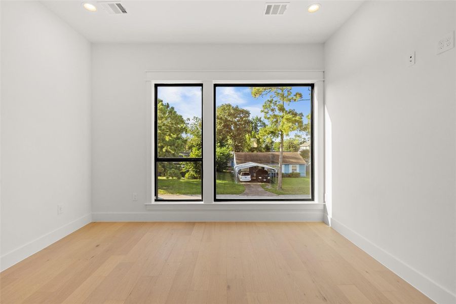 Natural light pours through oversized windows, creating a bright and inviting bedroom you'll look forward to calling your own.