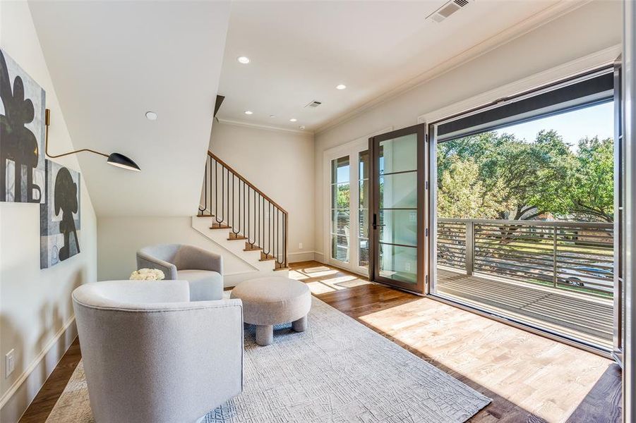 Living room featuring stairs, wood finished floors, ornamental molding, and recessed lighting Living room featuring stairs, wood finished floors, ornamental molding, and recessed lighting