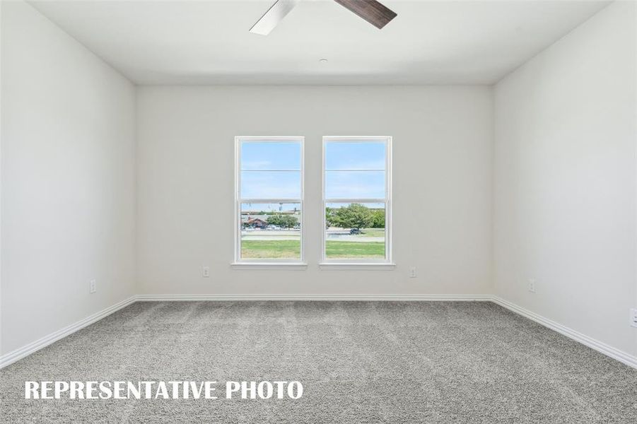 This peaceful light filled owner's bedroom is the perfect place to relax after a long day.  REPRESENTATIVE PHOTO