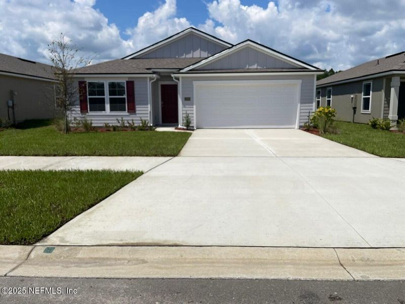 Front exterior of a new home in The Arbors, Jacksonville, FL, highlighting curb appeal (Image 11). Front exterior of a new home in The Arbors, Jacksonville, FL, highlighting curb appeal (Image 11).
