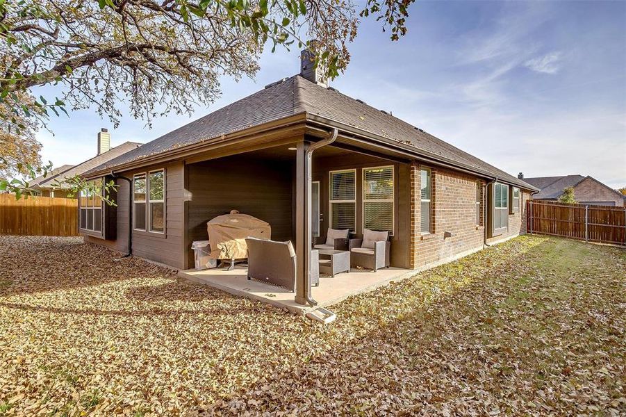 Back of property featuring outdoor lounge area and a patio