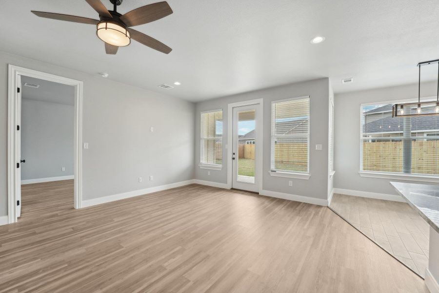 Unfurnished living room featuring recessed lighting, a healthy amount of sunlight, visible vents, and light wood finished floors