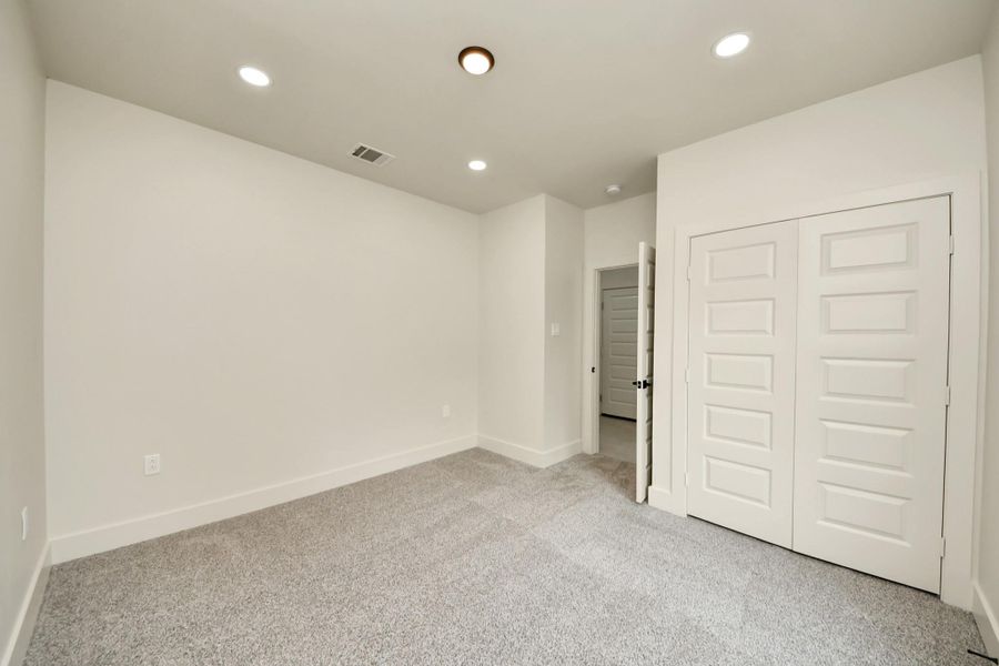 Spacious third bedroom featuring a large closet and neutral tones