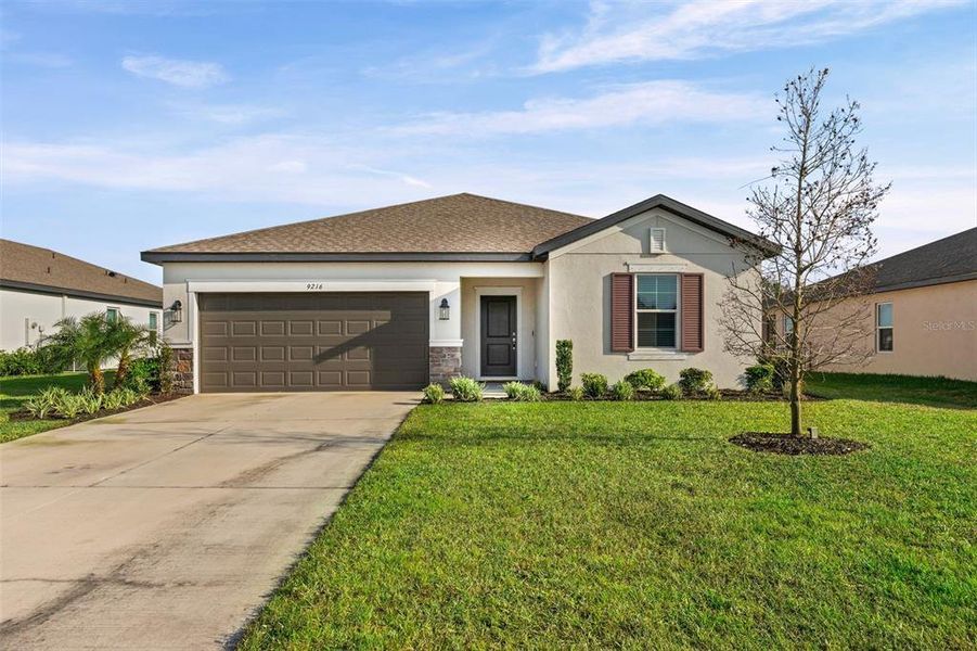 Front exterior of a new home in Summerwoods, Parrish, FL, highlighting curb appeal (Image 1). Front exterior of a new home in Summerwoods, Parrish, FL, highlighting curb appeal (Image 1).