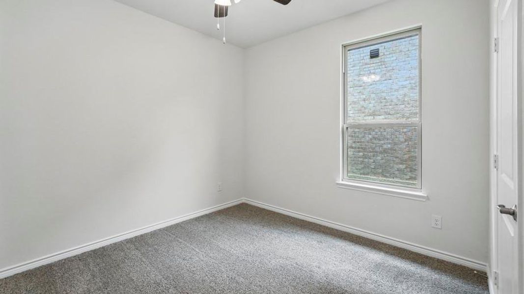 Spare room featuring carpet floors and ceiling fan