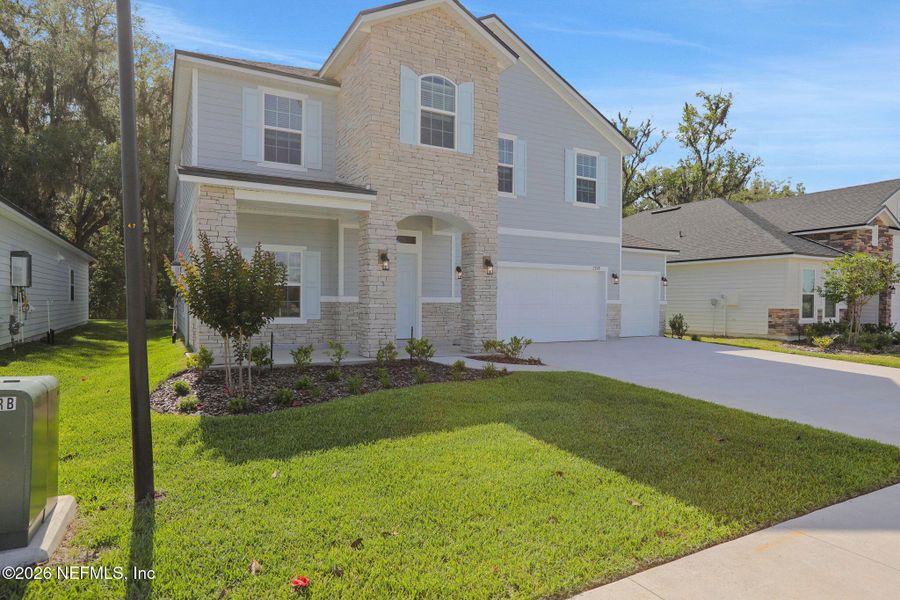 Front exterior of a new home in Jennings Farm, Middleburg, FL, highlighting curb appeal (Image 25). Front exterior of a new home in Jennings Farm, Middleburg, FL, highlighting curb appeal (Image 25).