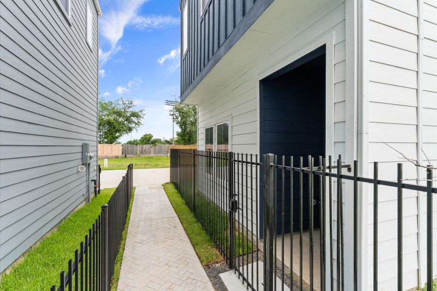 Step outside and follow this charming exterior hallpath, which gently guides you from the front door to the heart of the community courtyard. Framed by manicured landscaping and soft outdoor lighting, the walkway offers a welcoming transition from private living to shared green space.