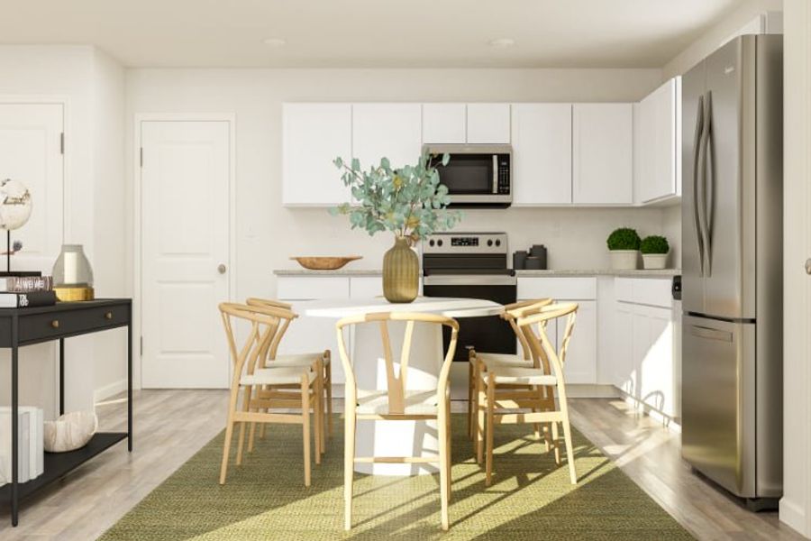A kitchen with a table and chairs.