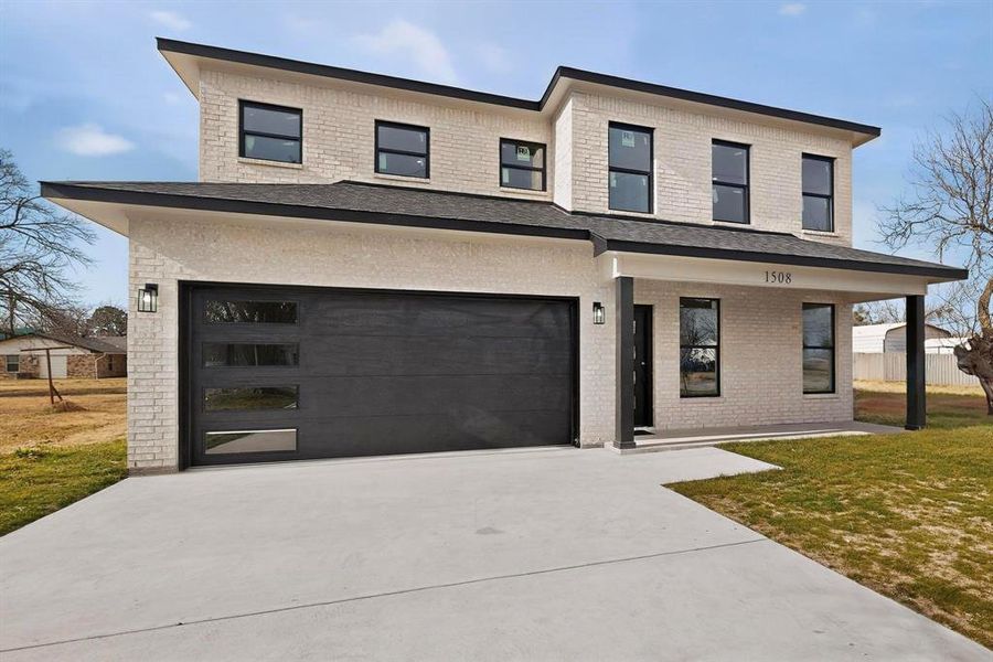 View of front of house featuring brick siding, a front lawn, a porch, concrete driveway, and a garage View of front of house featuring brick siding, a front lawn, a porch, concrete driveway, and a garage