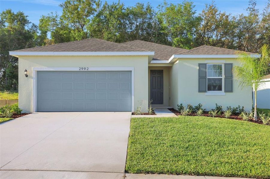 Front exterior of a new home in Seaport Village, Tavares, FL, highlighting curb appeal (Image 1).