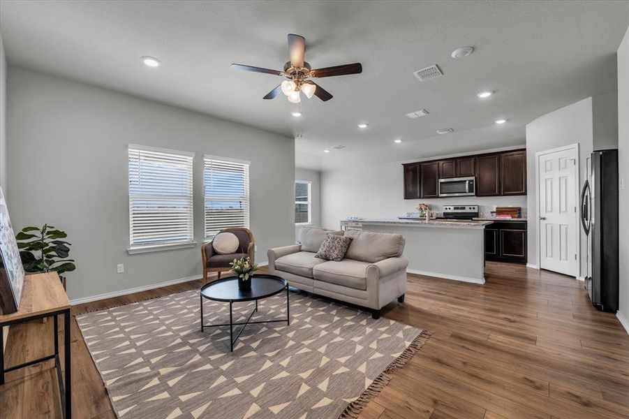 Living area featuring recessed lighting, neutral vinyl plank floors, and ceiling fan