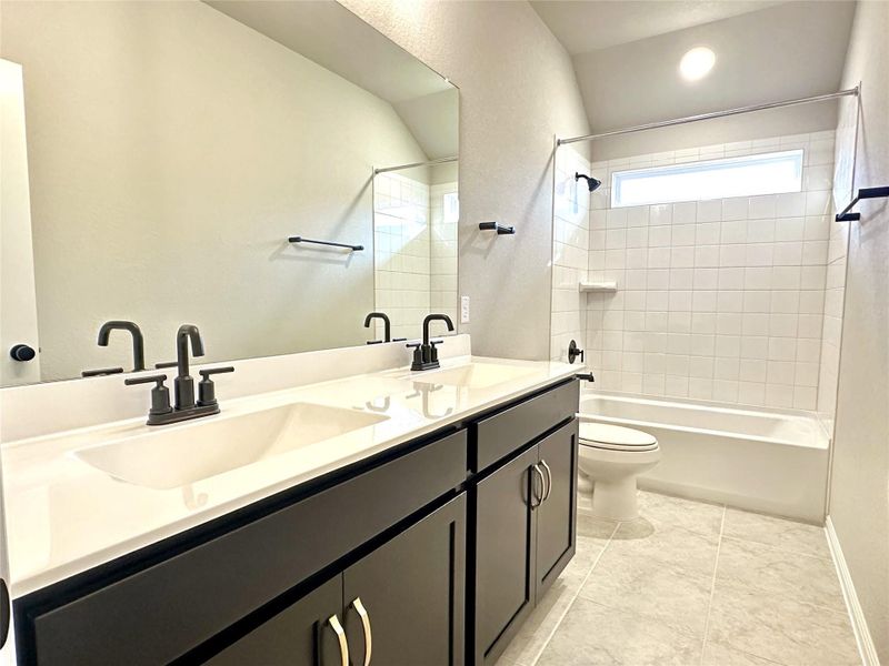 Bathroom-3- featuring toilet, double vanity, shower / bathtub combination, and baseboards Bathroom-3- featuring toilet, double vanity, shower / bathtub combination, and baseboards