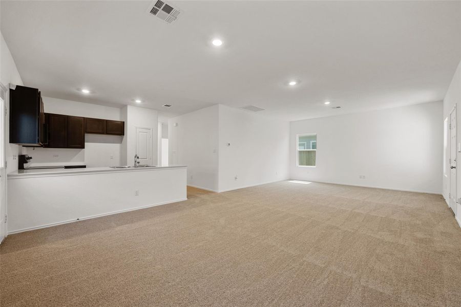 Unfurnished living room featuring recessed lighting and light colored carpet Unfurnished living room featuring recessed lighting and light colored carpet