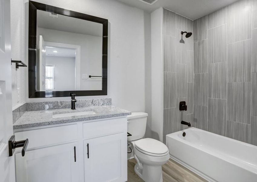 Secondary bathroom with a dual shower and tub.