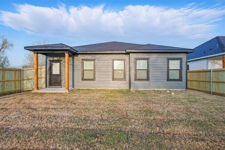 Back of house featuring a fenced backyard and a yard Back of house featuring a fenced backyard and a yard