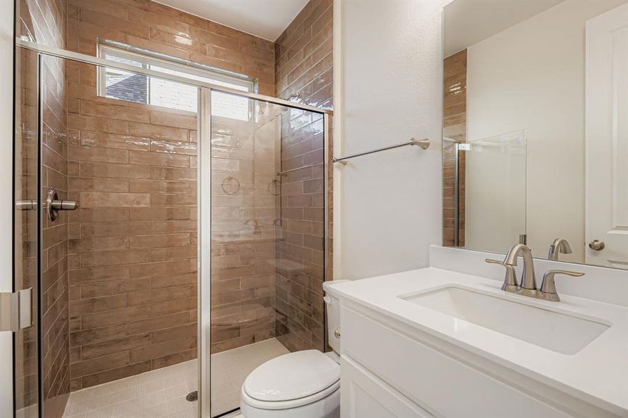 Bathroom featuring vanity and a stall shower Bathroom featuring vanity and a stall shower