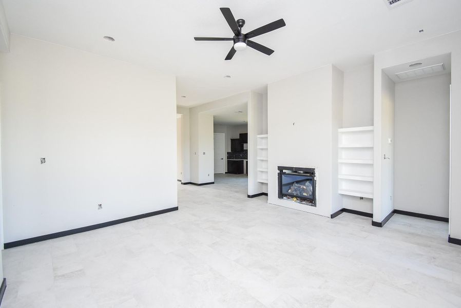 Family Room is huge with a fireplace and built-in shelves. Family Room is huge with a fireplace and built-in shelves.