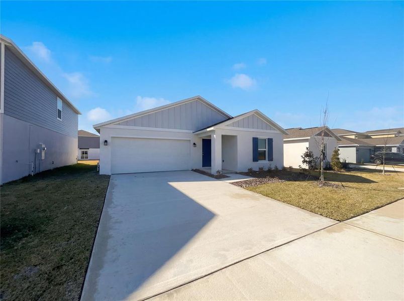 Front exterior of a new home in Peace Creek Reserve, Winter Haven, FL, highlighting curb appeal (Image 18).