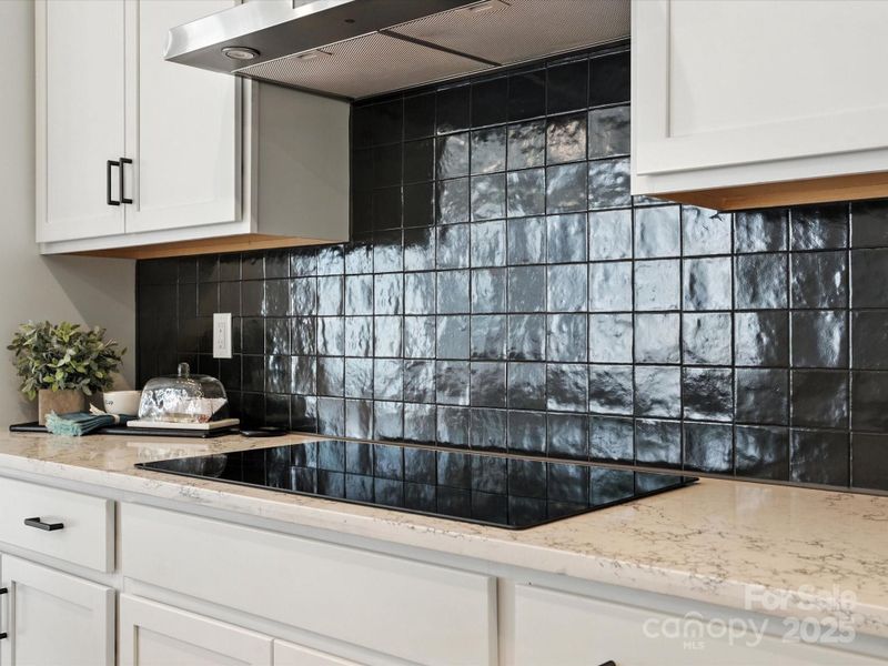 Electric Cooktop and Designer Selected Backsplash. *Model Photos | Actual Finishes, Structural Selection, and Orientation May Vary.