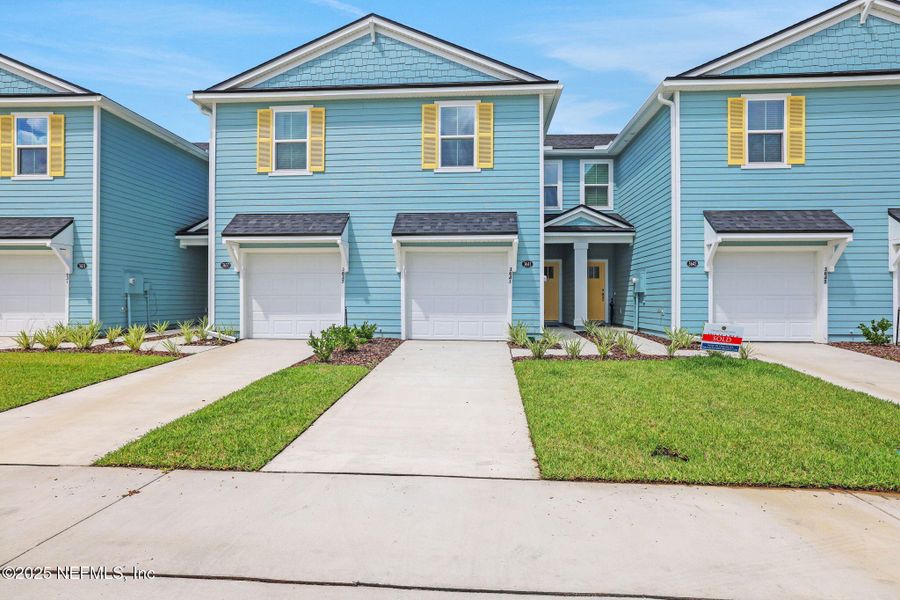 Front exterior of a new home in Atlantis Pointe, Middleburg, FL, highlighting curb appeal (Image 2).