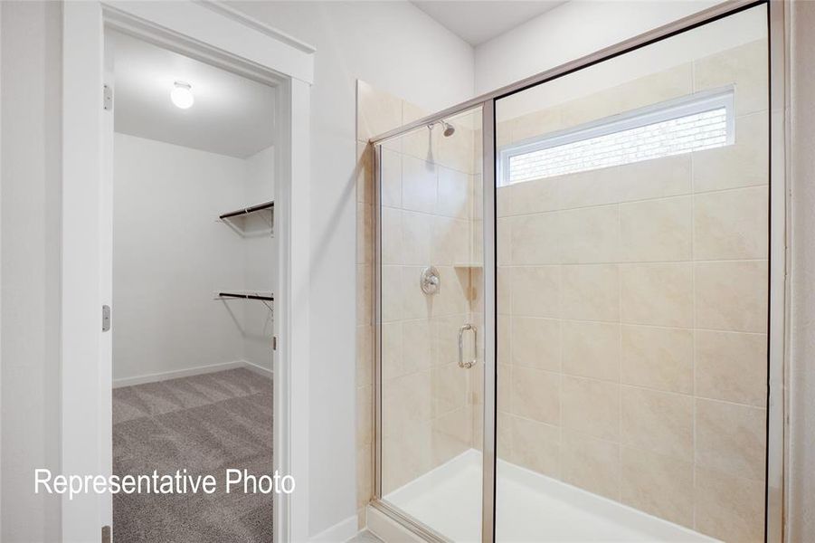 Bathroom featuring a shower with door