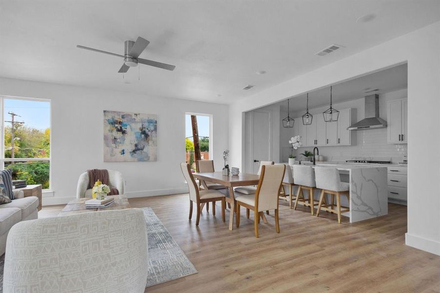 Dining area with ceiling fan and light hardwood / wood-style flooring