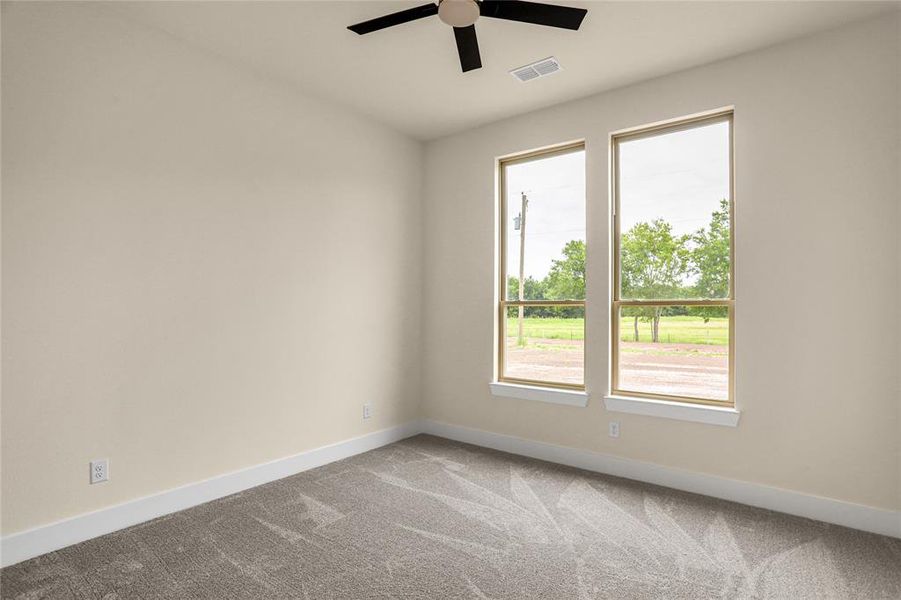 Unfurnished room with carpet flooring and a ceiling fan Unfurnished room with carpet flooring and a ceiling fan