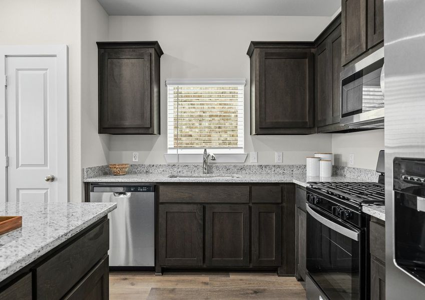 The kitchen has sprawling granite countertops.