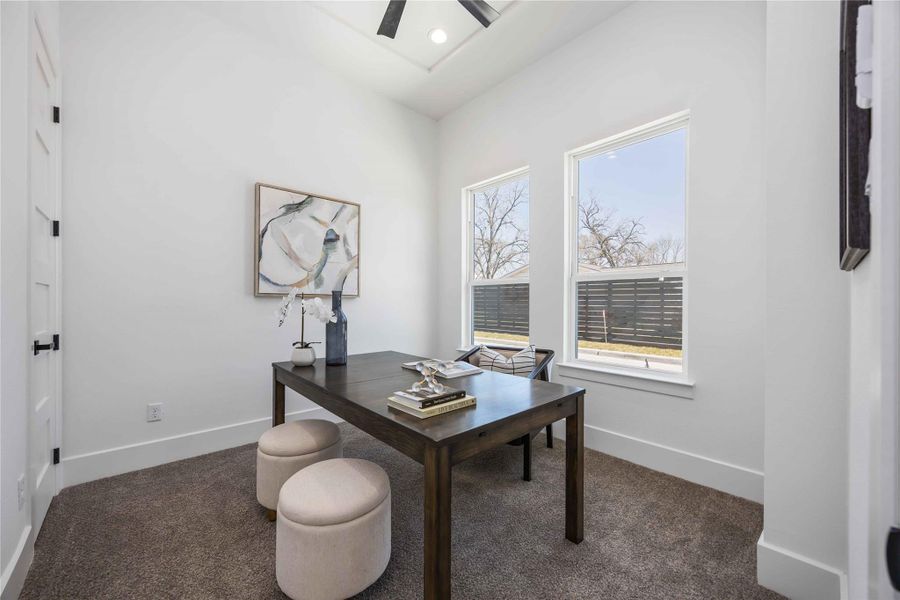 Versatile first-floor secondary bedroom ideal for a guest suite or private office, with an attached full bath and walk-in closet.