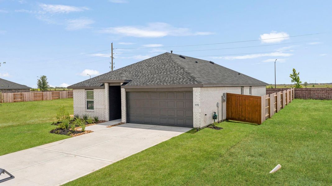 Front exterior of a new home in Sunterra Lakes, Brookshire, TX, highlighting curb appeal (Image 2). Front exterior of a new home in Sunterra Lakes, Brookshire, TX, highlighting curb appeal (Image 2).