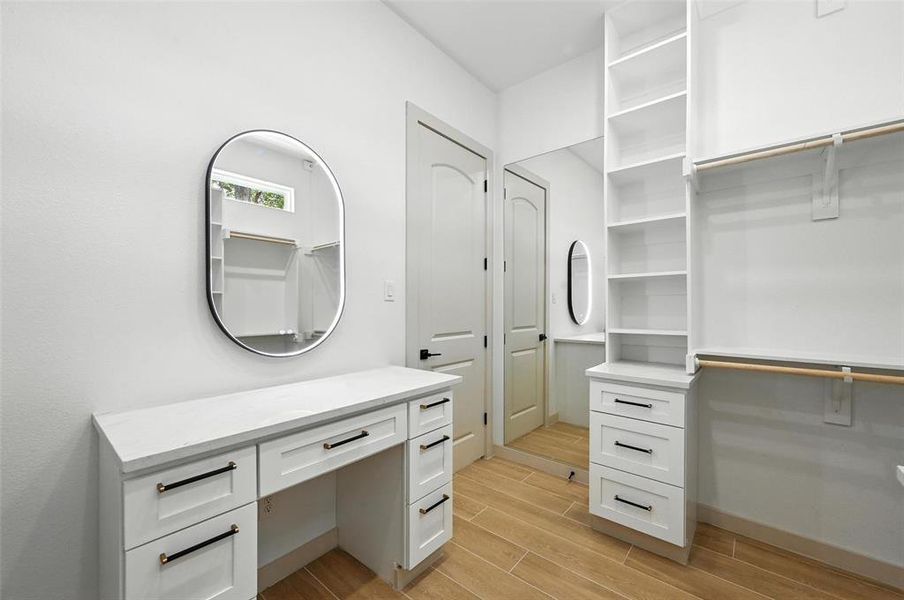 Walk in closet with wood tiled floors Walk in closet with wood tiled floors