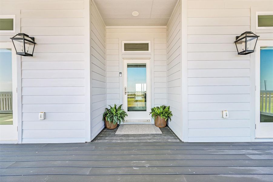 The front entry welcomes guests with clean architectural lines, refined finishes, and inviting coastal style. From the moment you arrive, the home feels both grand and warm.