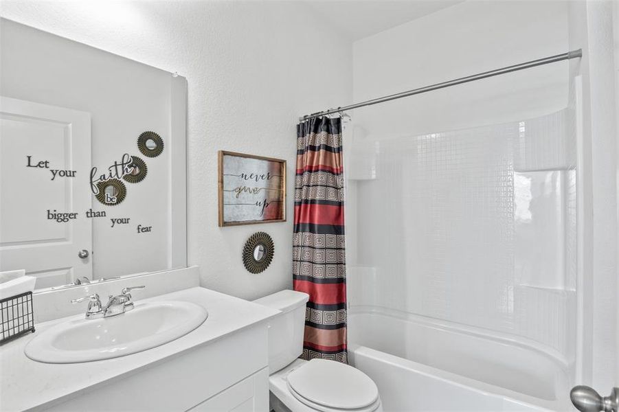 Primary Bathroom featuring vanity and shower / tub combo with curtain
